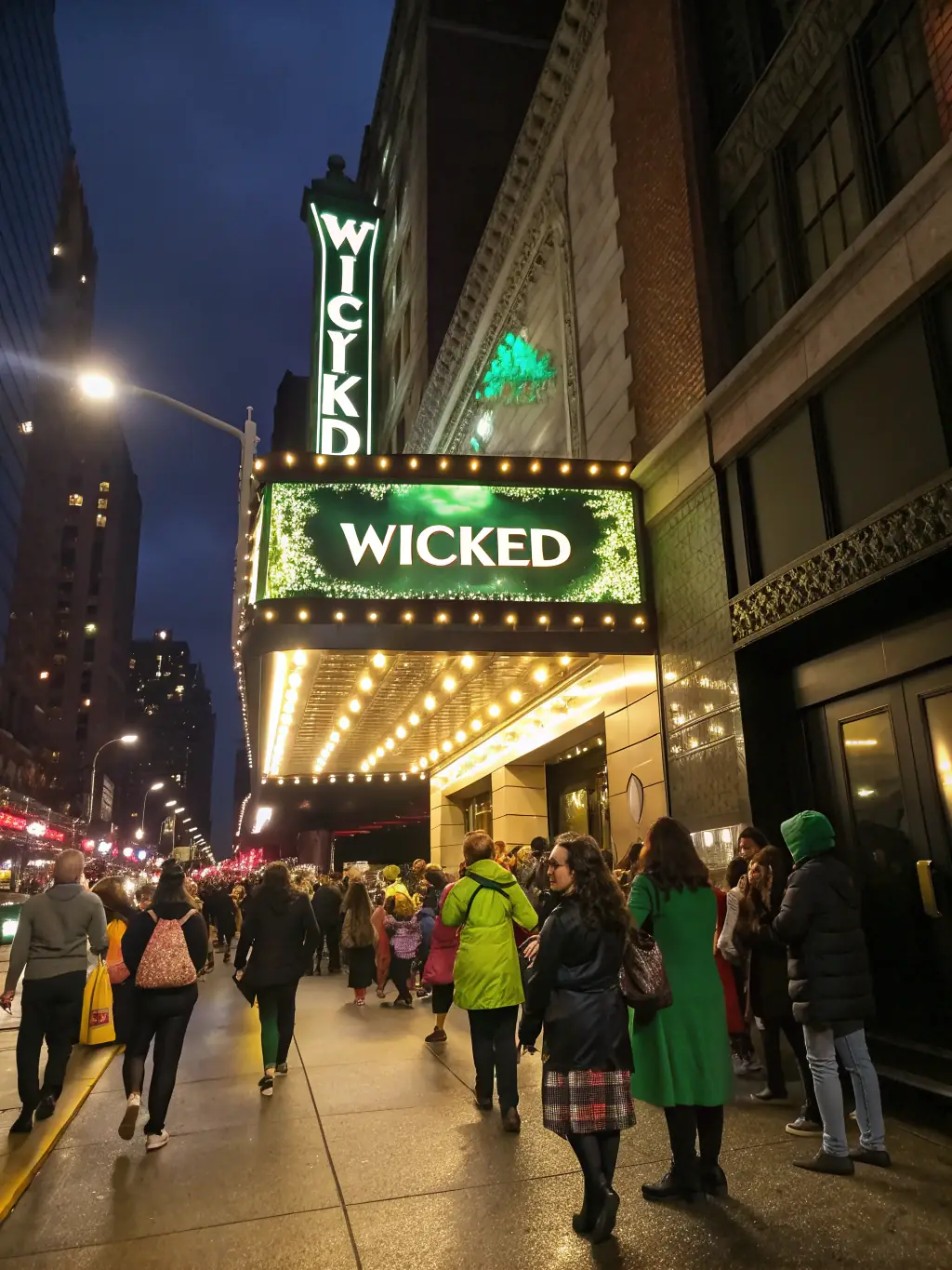 A captivating image of a Broadway theater in New York City, with its marquee brightly lit and theatergoers eagerly entering to watch a performance.