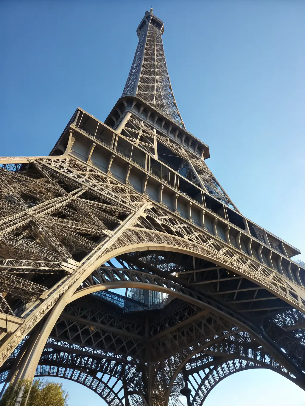 A vibrant image of the Eiffel Tower in Paris, showcasing the iconic landmark against a clear blue sky, capturing the essence of Parisian culture and romance.